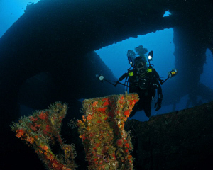 An underwater photographer inside the Wit Shoal II in St.... by Juan Torres 